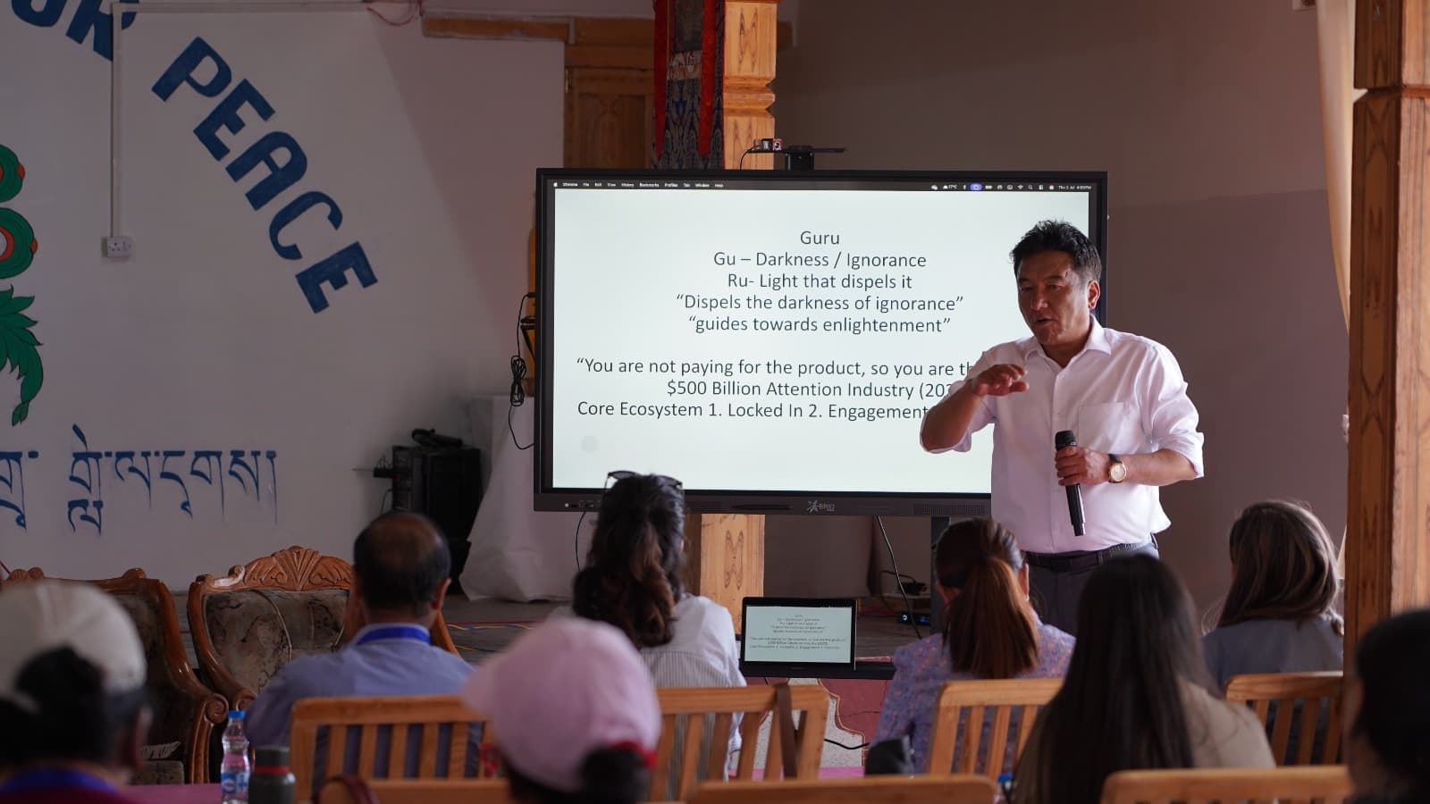 A resource person presenting on digital pedagogy at an interactive display screen during a DIET Leh ICT workshop