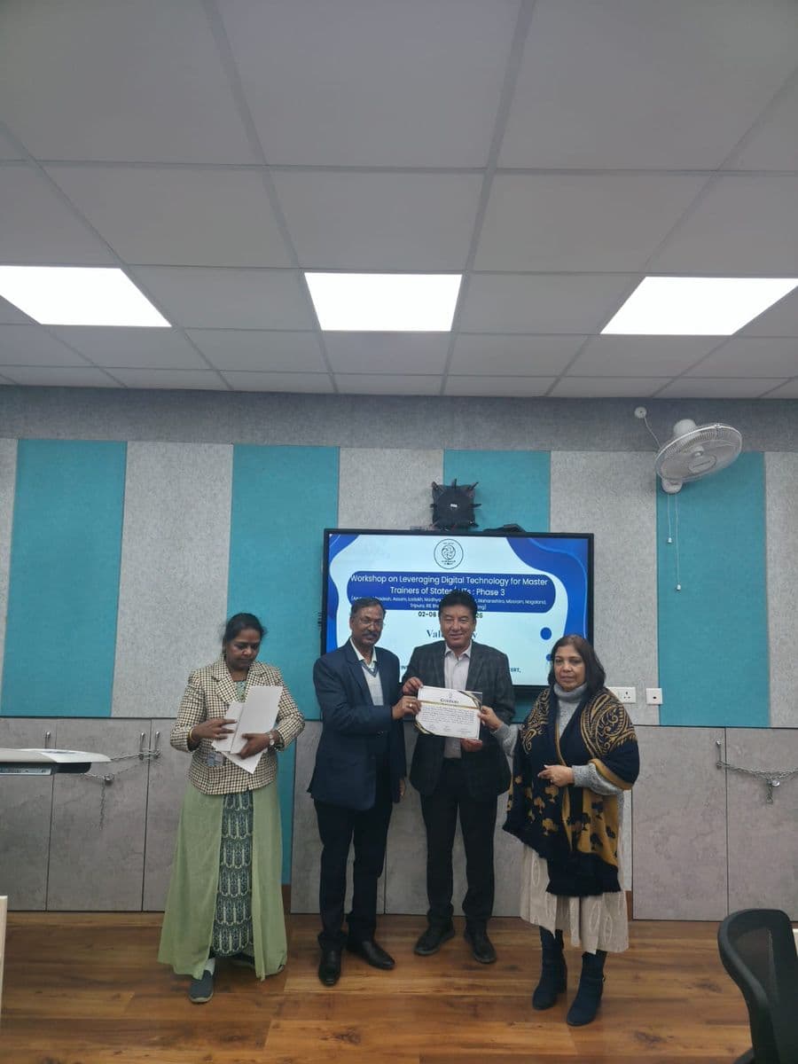 A certificate being presented to a participant from Ladakh at the valedictory session of the Workshop on Leveraging Digital Technology for Master Trainers of States/UTs, Phase 3, with the workshop banner on a screen behind