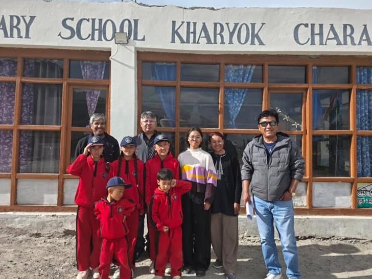 The monitoring team with students and teachers outside Govt. Primary School, Kharyok Charasa
