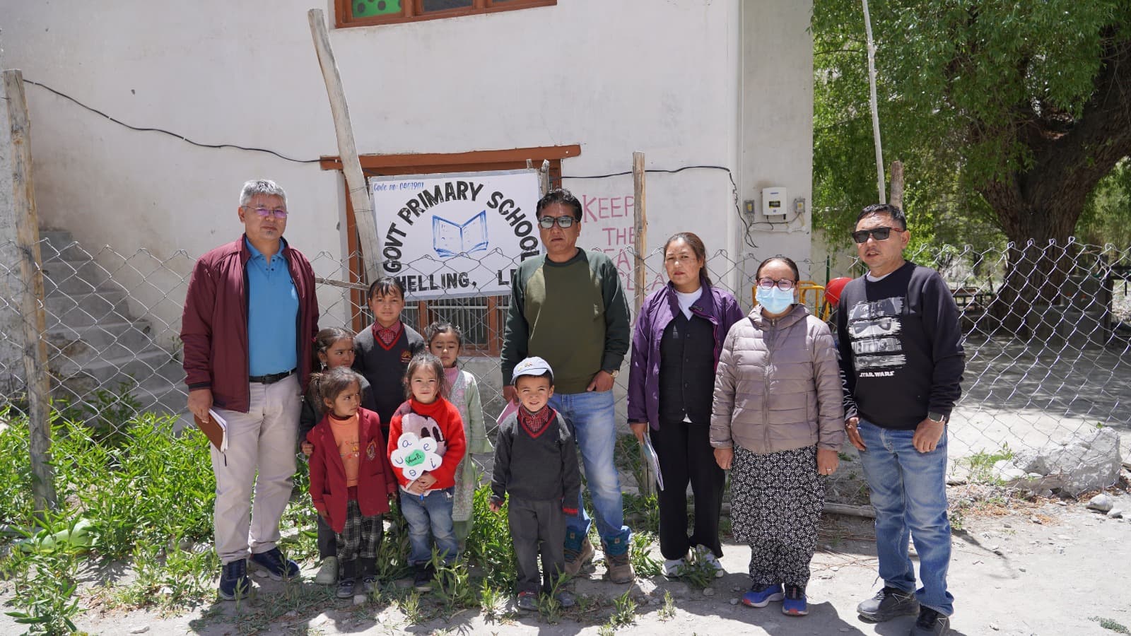 The monitoring team with young students and staff at Govt. Primary School, Shelling