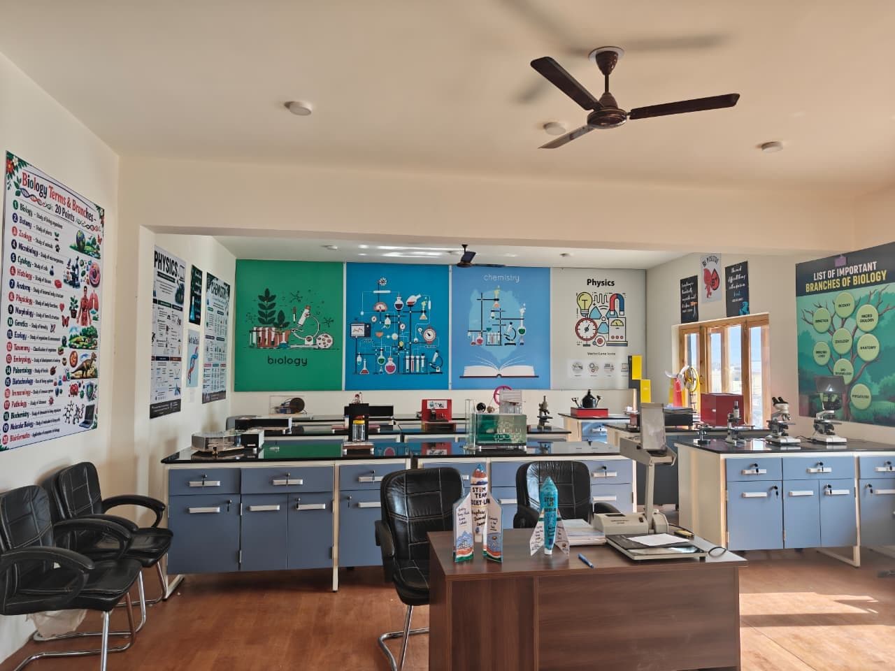 The Model Science Laboratory at DIET Leh, with blue lab benches, microscopes and biology, chemistry and physics wall panels